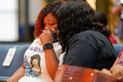 Tamika Palmer, mother of Breonna Taylor, is comforted by a family member during a news conference announcing a $12 million civil settlement between the estate of Breonna Taylor and the City of Lousiville, in Louisville, Kentucky, Sept, 15, 2020.