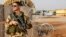 FILE - A French air force soldier on guard near a Hartford drone, at the Niamey military base, in Niger.