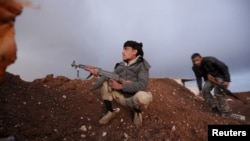 Rebel fighters of the Al-Furqan brigade sit on a look-out point with their weapons in Aziziyah village, southern Aleppo countryside, Syria, March 5, 2016. 