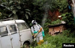 A State Endemics Control health agent fumigates insecticide in an area to kill mosquitoes during a campaign against yellow fever in Sao Paulo, Brazil, Jan. 17, 2018.