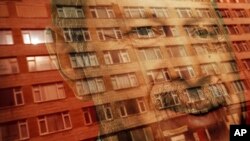 A building is reflected onto a poster of Turkey's President Recep Tayyip Erdogan, decorating a bus stop in Istanbul, June 15, 2018. Turkey holds parliamentary and presidential elections on June 24, 2018.