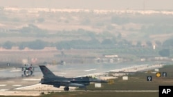 FILE - Turkish fighter jets taxi on the runway of the Incirlik airbase, southern Turkey, Aug. 31, 2013.