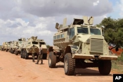 FILE - African Union soldiers stop near to Beledogle airfield, Somalia, to help secure the area from al-Shabab insurgents, Oct 11, 2012.