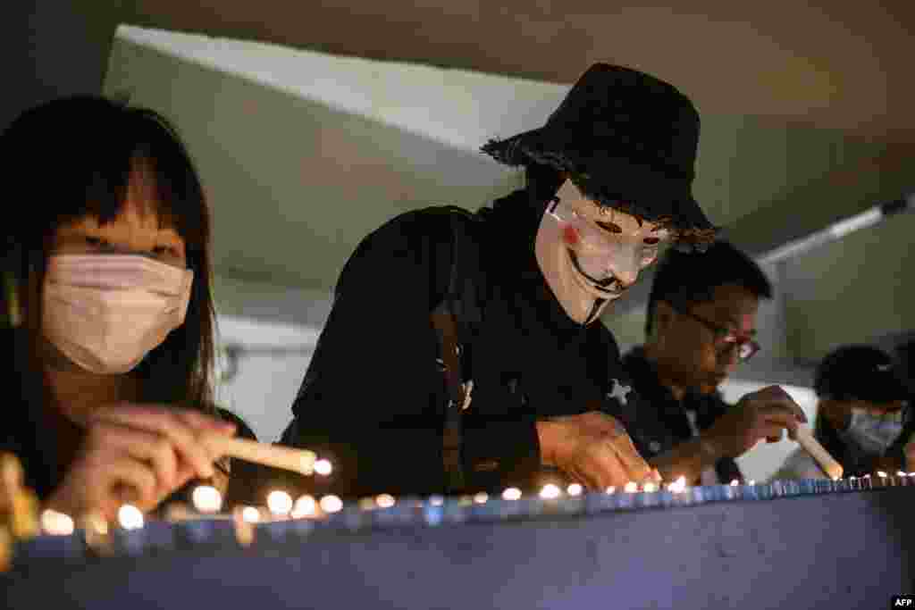 Mourners light candles as they pay their respects at the car park where student Alex Chow, 22, fell during a recent protest in the Tseung Kwan O area on the Kowloon side of Hong Kong.