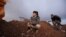 Rebel fighters of the Al-Furqan brigade sit on a look-out point with their weapons in Aziziyah village, southern Aleppo countryside, Syria, March 5, 2016. 