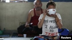 A Tibetan protester eats after the conclusion of a 24-hour hunger strike was held to express solidarity with compatriots who were victims of a Chinese crackdown in Ngaba, Sichuan Province in March, at the Tibetan Youth Club in Katmandu, Nepal, April 2011.