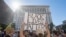 Supporters of Black Lives Matter, hold signs during a protest outside the Hall of Justice as they demonstrate against the death of George Floyd, in Los Angeles, California on June 10, 2020. (Photo by Mark RALSTON / AFP)
