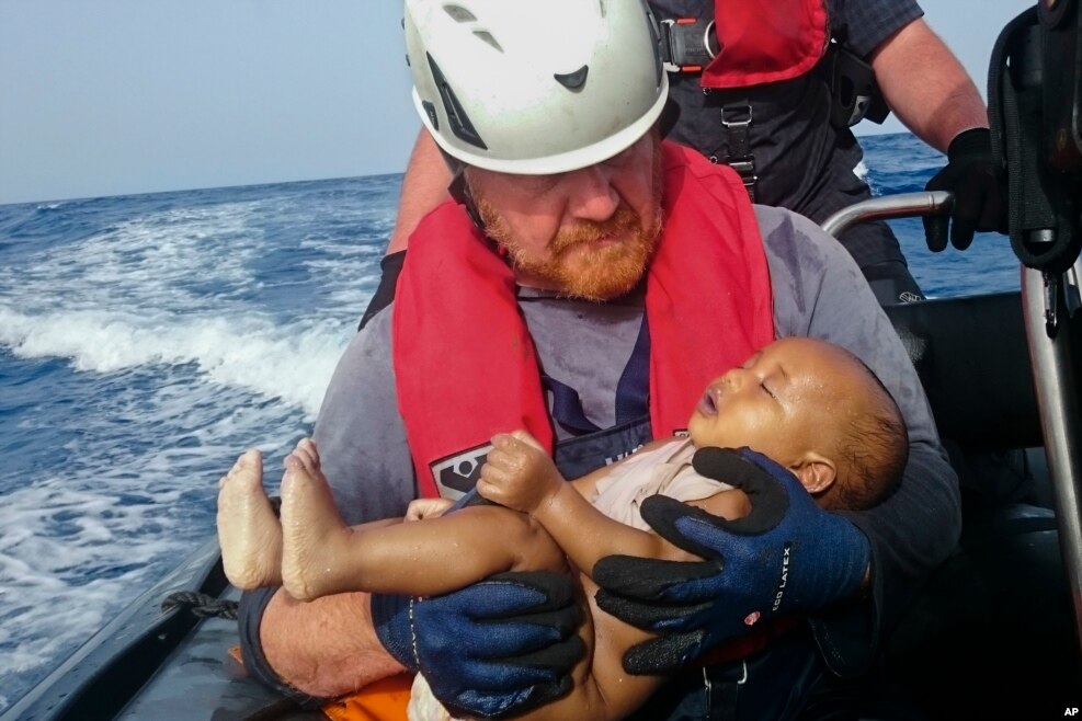 A Sea-Watch humanitarian organization crew member holds a drowned migrant baby, during a rescue operation off the coasts of Libya.&nbsp;Survivor accounts have pushed to more than 700 the number of migrants feared dead in Mediterranean Sea shipwrecks over three days in the past week.