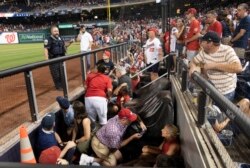 FILE - Fans take cover after apparent gun shots were heard during the game between the Washington Nationals and the San Diego Padres at Nationals Park in Washington, D.C., July 17, 2021. (Brad Mills-USA Today Sports)