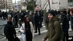 Students protest against alleged police abuses in front of Henri Bergson College, in Paris, France, Feb. 23, 2017. 