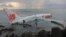 A Lion Air plane is seen in the water after it missed the runway in Denpasar, Bali in this picture provided by the Indonesian police, Apr. 13, 2013.
