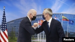 U.S. President Joe Biden and NATO Secretary General Jens Stoltenberg elbow bump as they meet during a NATO summit, at the Alliance's headquarters in Brussels, Belgium, June 14, 2021. (Stephanie Lecocq/REUTERS)