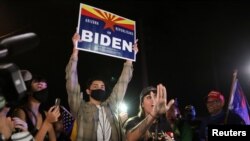 A supporter of U.S. President Donald Trump defends the right of a presidential nominee Joe Biden supporter to be at a gathering during a protest about the early results of the 2020 U.S. presidential election, in Phoenix, Arizona, Nov. 6, 2020.
