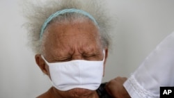 Justina Batista, 90, gets a shot of China's Sinovac vaccine in Brasilia, Brazil, Feb. 17, 2021.