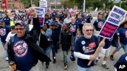 Members and family of unions walk in the annual Labor Day parade in Detroit, Monday, Sept. 5, 2011. (AP File Photo/Paul Sancya)
