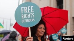 Rights activists gather in front of the Justice Palace during the opening hearing of the trial of 11 human rights activists accused of terrorism charges, in Istanbul, Turkey, Oct. 25, 2017. Eight of the activists were later released.