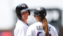 FILE - Adley Rutschman, left, of the American League, talks with Rachel Balkovec during the third inning of the MLB All Star Futures baseball game, July 11, 2021, in Denver.