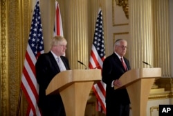 Britain's Foreign Secretary Boris Johnson, left and U.S. Secretary of State Rex Tillerson hold a press conference after their meeting on Libya at Lancaster House in London, Sept. 14, 2017.