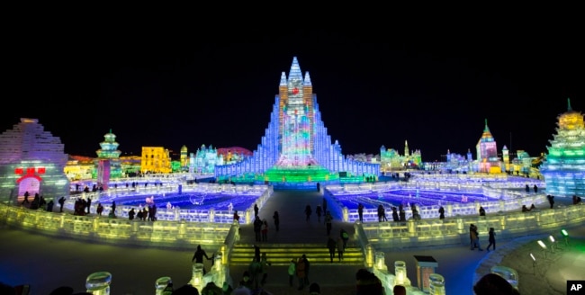 In this photo taken Wednesday, Jan. 8, 2014, people visit the Harbin International Ice and Snow Sculpture Festival in Harbin, China. (AP Photo/Vincent Thian)