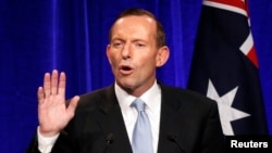 Australia's conservative leader Tony Abbott gestures as he claims victory in Australia's federal election during an election night function in Sydney, Sept. 7, 2013.