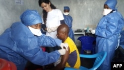 FILE - This handout photo released by Doctors Without Borders (MSF) Nov. 14, 2019, shows a young man receiving an Ebola vaccine at MSF facilities in the North Kivu capital of Goma, DRC. Both Guinea and the DRC are reporting a reemergence of the virus. 