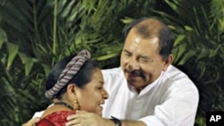 Nicaraguan President Daniel Ortega greets to Nobel Peace Prize recipient, Guatemalan indigenous leader Rigoberta Menchu, during a ceremony starting the school year in the country in Ciudad Sandino, about 17 kms west Managua, February 15, 2011