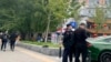 FILE - Police officers stand near a bridge where social media videos earlier appeared to show smoke and protest banners in Beijing, Oct. 13, 2022. 