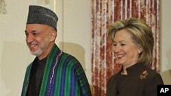 U.S. Secretary of State Hillary Clinton and Afghan President Hamid Karzai arrive for the opening of the US-Afghanistan bilateral discussions at the Department of State, 11 May 2010