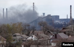 Smoke rises above a plant of Azovstal Iron and Steel Works in Mariupol