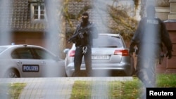 FILE - German special police forces SEK stand guard outside the building of the German Federal Supreme Court (Bundesgerichtshof) in Karlsruhe, Germany, Dec. 15, 2015.