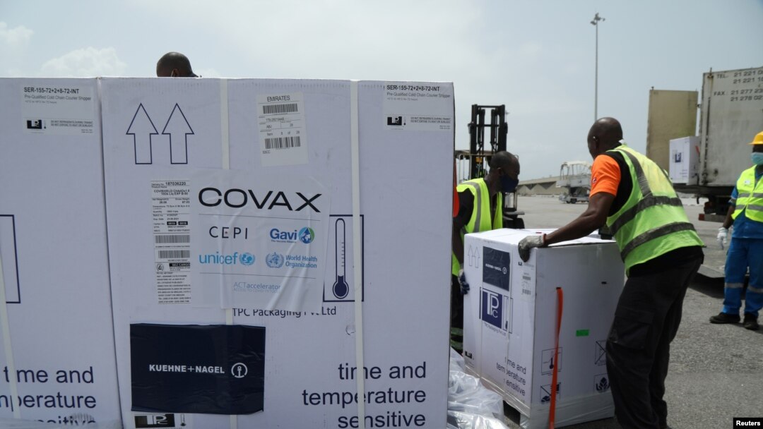 FILE - Workers offload boxes of COVID-19 vaccines distrubuted to lower-income countries under the COVAX initiative, in Abidjan, Ivory Coast, Feb. 26, 2021. 