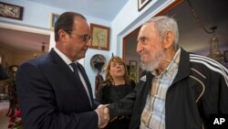 Mantan pemimpin Kuba, Fidel Castro (kanan), berjabat tangan dengan Presiden Perancis Francois Hollande di Havana (11/5). (AP/Alex Castro)
