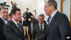 Russian Foreign Minister Sergey Lavrov, right, shakes hands with Co-chairman of pro-Kurdish People's Democratic Party, or HDP, Selahattin Demirtas prior to a meeting in Moscow, Russia, Dec. 23, 2015.