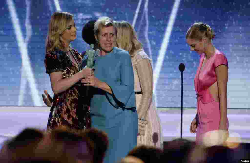 Frances McDormand reacts as she is presented the award for Outstanding Performance by a Cast in a Motion Picture for &quot;Three Billboards Outside Ebbing, Missouri&quot; by Brie Brie Larson (L) during the 24th Screen Actors Guild Awards in Los Angeles, California, Jan. 21, 2018.