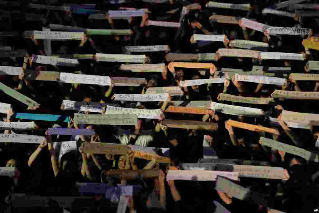 Attendees hold up banners some with words "Waiting for you to come home" and "Hong Kong have you, mothers have a hope" during a rally by mothers in Hong Kong, July 5, 2019.