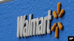 Signage is pictured at a Walmart store Tuesday, Aug. 4, 2020, in Oklahoma City. Walmart delivered strong profits and sales that beat Wall Street expectations for its fiscal second quarter helped by shoppers focused on buying food and other items as…