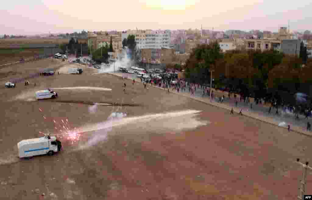 Turkish riot police use tear gas and water cannon to disperse Turkish-Kurd demonstrating on the Turkish side as Syrian Kurds gather on the other side of the border in Mardin&#39;s Nusaybin district, Turkey. Kurdish people protest against the construction by the Turkish government of a 2.5-kilometer-long wall along the border.