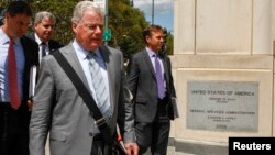 FILE - Shand Stephens (2nd R), a lawyer for Arab Bank Plc, exits the Brooklyn Federal Court in Brooklyn, New York, Aug. 14, 2014.