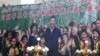 FILE - A propaganda poster showing Chinese President Xi Jinping with ethnic minority children and the slogan which reads "Party Secretary Xi Jinping and Xinjiang's multi ethnic residents united heart to heart" decorates the side of a building in Kashgar, 