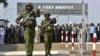 Ivorian troops take part in a ceremony marking the handover to them of the French military base in Abidjan, Ivory Coast, on Feb. 20, 2025. The sign reads: "See you soon."