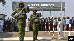 Ivorian troops take part in a ceremony marking the handover to them of the French military base in Abidjan, Ivory Coast, on Feb. 20, 2025. The sign reads: "See you soon."