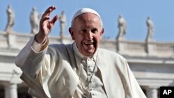 Pope Francis waves as he tours St. Peter's Square ahead of his weekly general audience, at the Vatican, Wednesday, April 12, 2017.