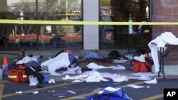 Dead bodies and debris lay on the ground after a shooting involving Rep. Gabrielle Giffords, D-Ariz, outside a shopping center in Tucson, Arizona, 08 Jan 2011