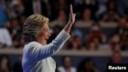 Democratic presidential nominee Hillary Clinton waves as she arrives to accept the nomination