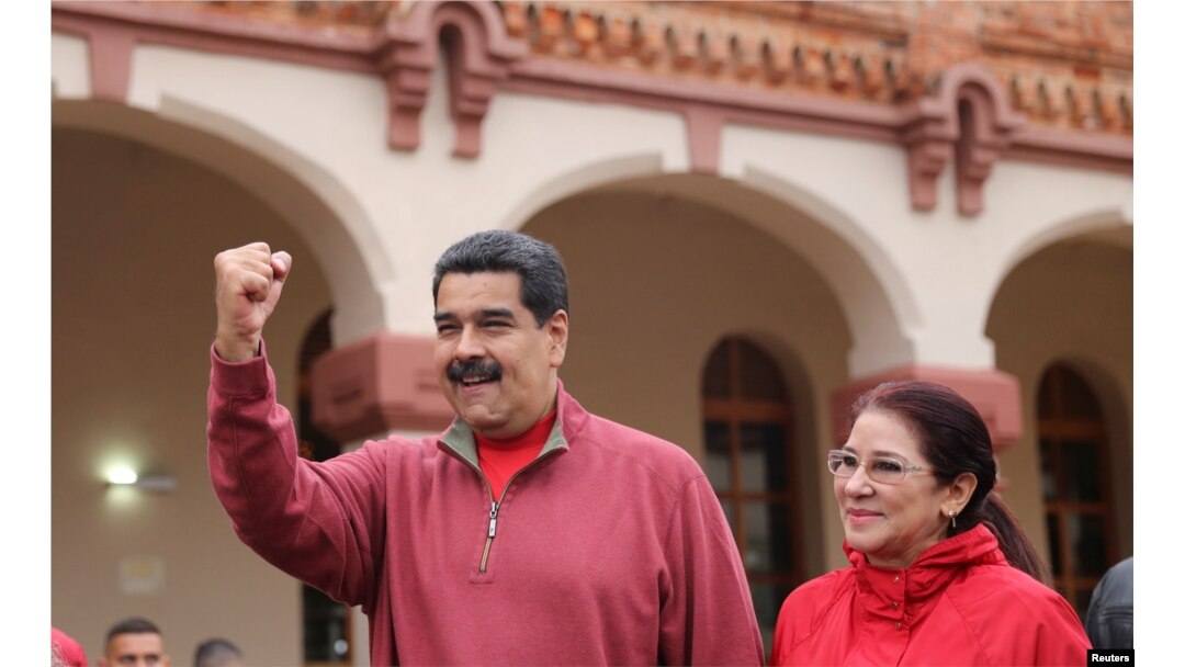 Venezuela's President Nicolas Maduro greets supporters with his wife Cilia Flores during an appearance at a military base in Caracas, Dec. 8, 2016.