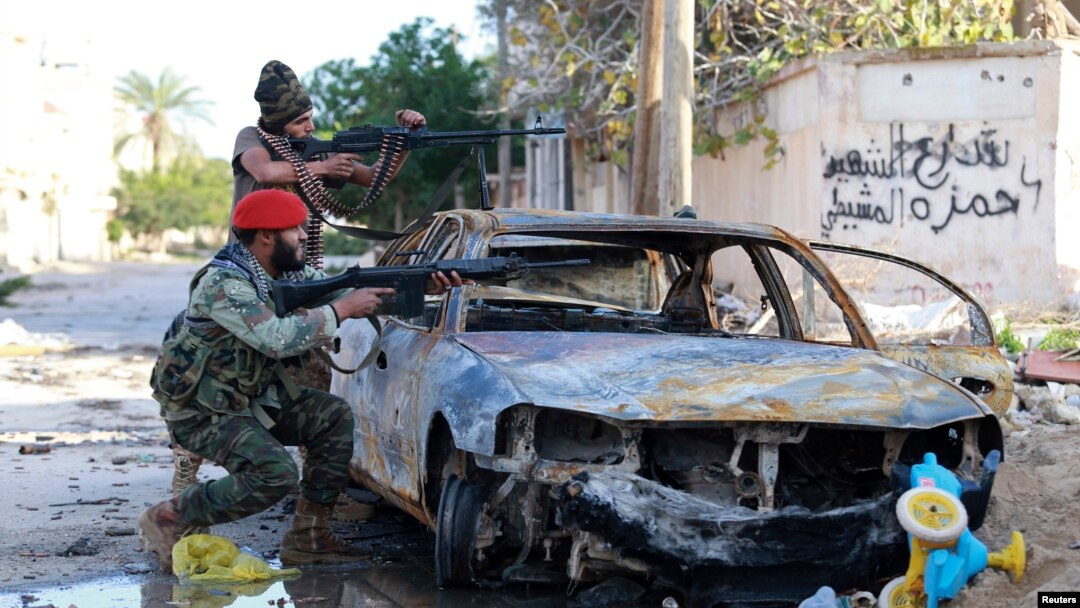 Tentara Libya pro-pemerintah mengarahkan senjatanya dalam bentrokan dengan pemberontak di Benghazi, Desember 2014.