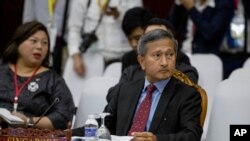 FILE - Singapore's Foreign Minister Vivian Balakrishnan, right, attends the Special ASEAN-China Foreign Ministers' meeting on the Novel Coronavirus Pneumonia in Vientiane, Laos, Feb. 20, 2020. 