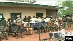 FILE - Cameroon's military displays weapons and other equipment it says were seized from separatists, in Bamenda, Cameroon, March 4, 2021. 