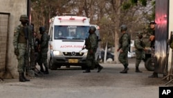 An ambulance leaves the Litoral Penitentiary after a prison riot, in Guayaquil, Ecuador, Wednesday, September 29, 2021. (AP Photo/Angel DeJesus)