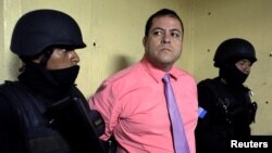 Congressman Julio Juarez Ramirez, who is accused of plotting the murders of two journalists in 2015, is escorted by police officers to court in Guatemala City, Guatemala, Jan. 13, 2018.